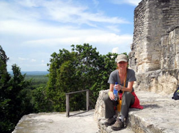 A woman at the top of the Temple 4 in Tikal