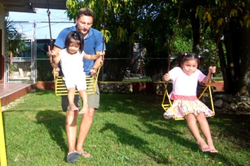 Volunteer playing with 2 girls